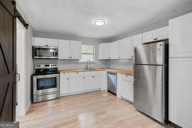 a kitchen with a refrigerator stove and microwave