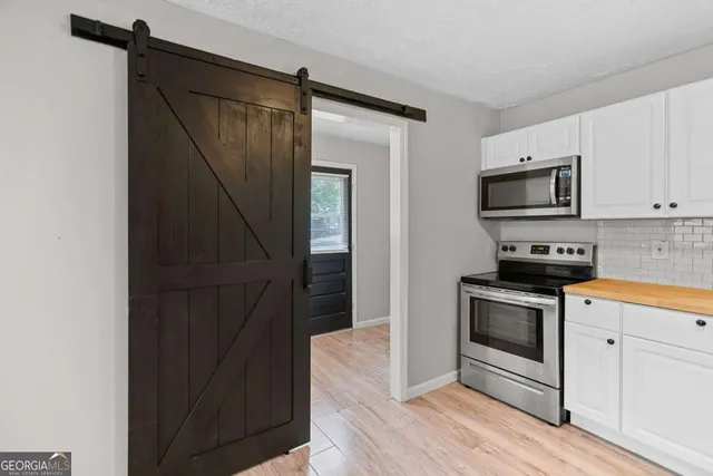 a kitchen with a refrigerator stove and microwave