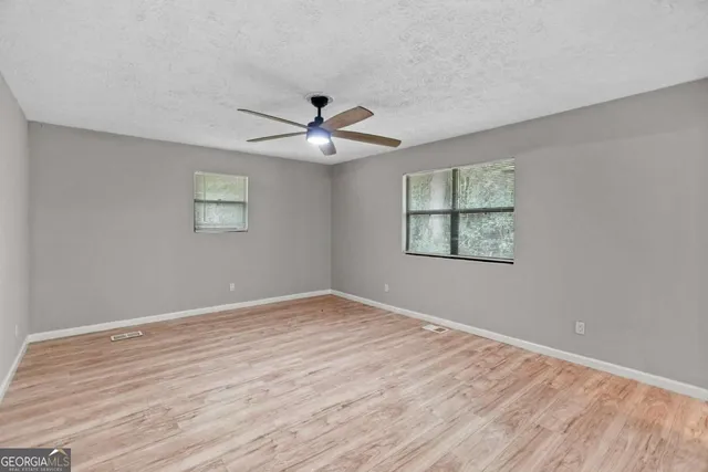wooden floor in an empty room with a window