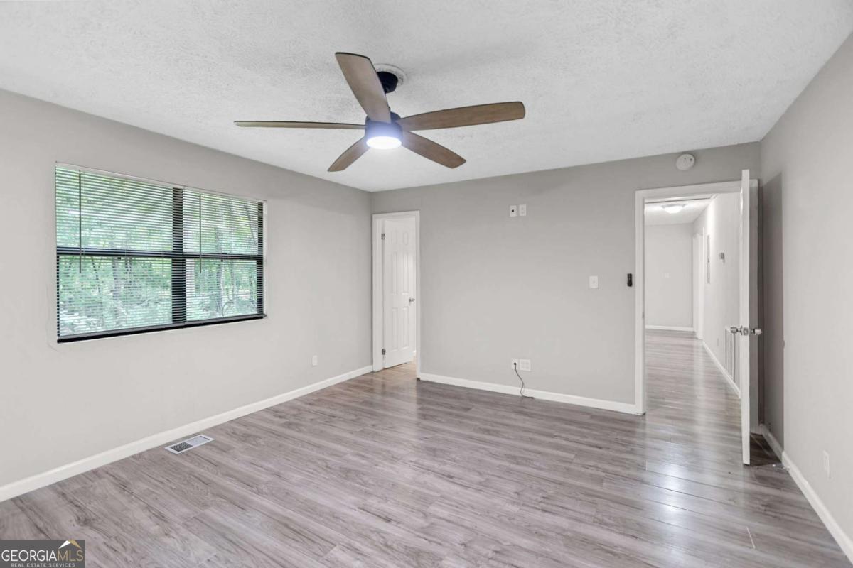 1248 Cannonville Road LaGrange, GA 30240 - Photo 21 of 46 wooden floor in an empty room with a window
