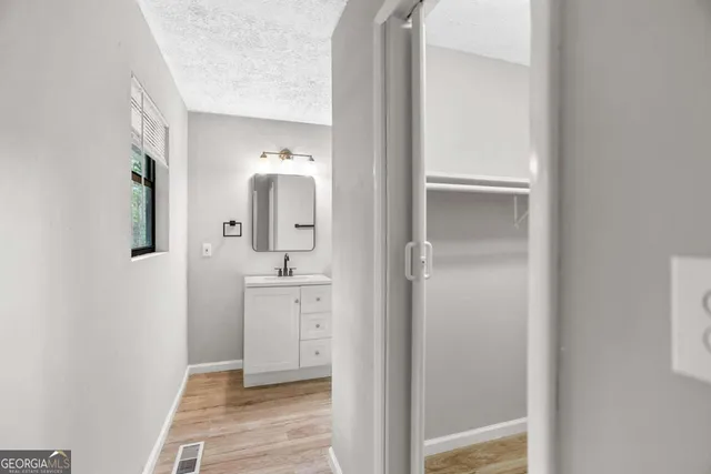 a bathroom with a shower and a sink
