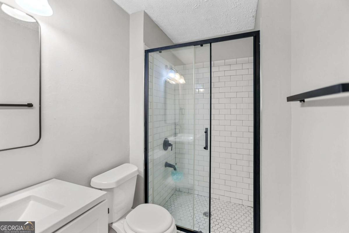 1248 Cannonville Road LaGrange, GA 30240 - Photo 25 of 46 a bathroom with a toilet shower vanity and a sink