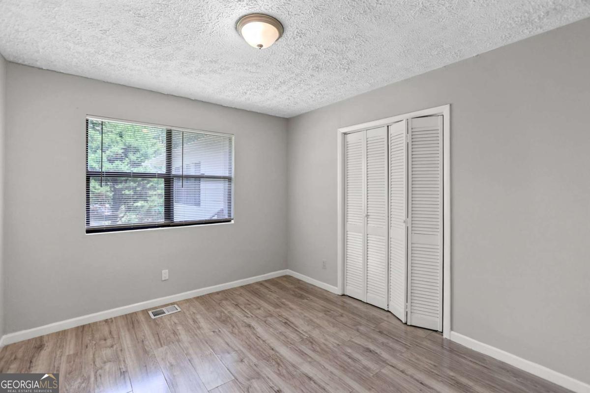 1248 Cannonville Road LaGrange, GA 30240 - Photo 27 of 46 an empty room with wooden floor and windows