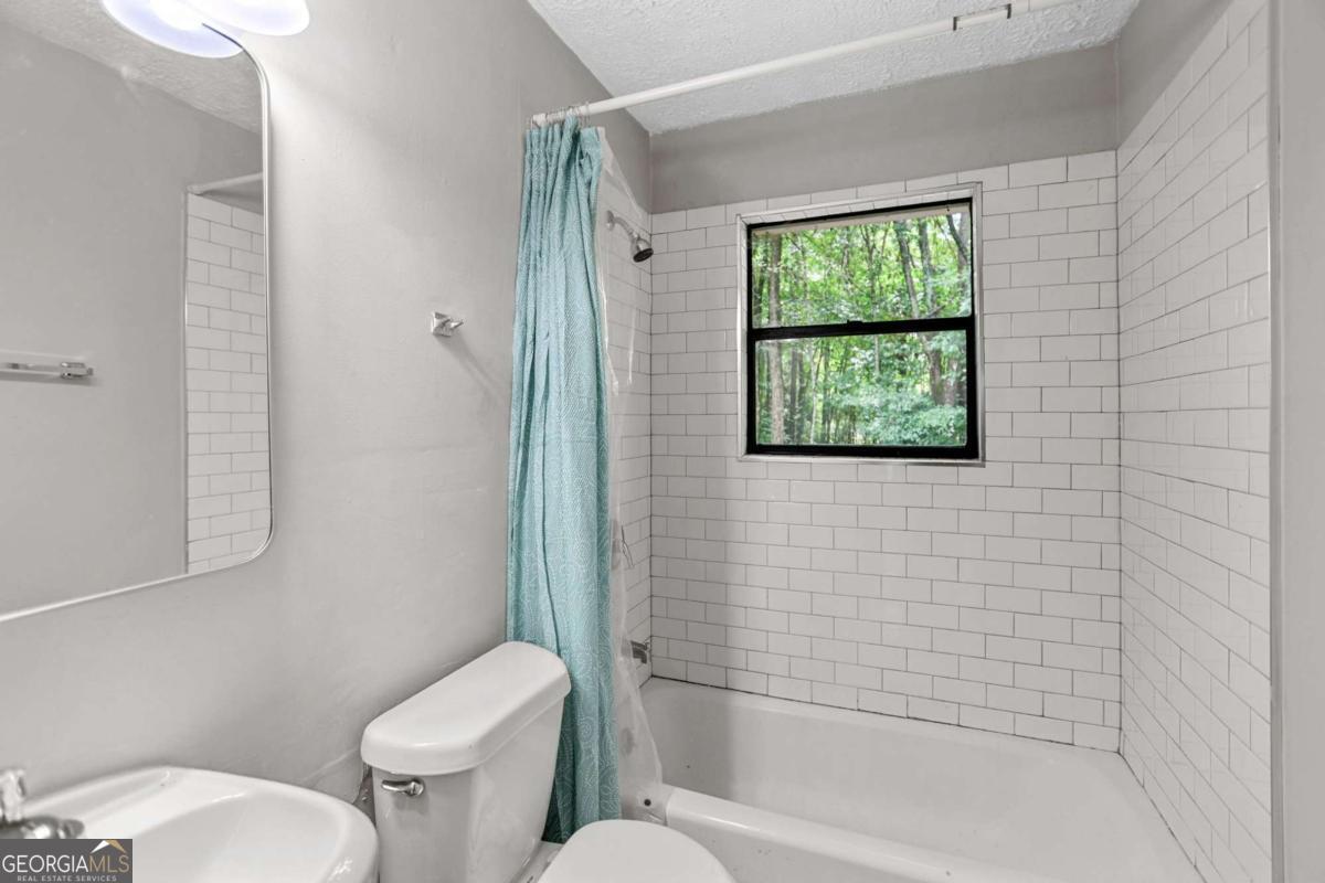 1248 Cannonville Road LaGrange, GA 30240 - Photo 29 of 46 a white toilet sitting next to a bath tub