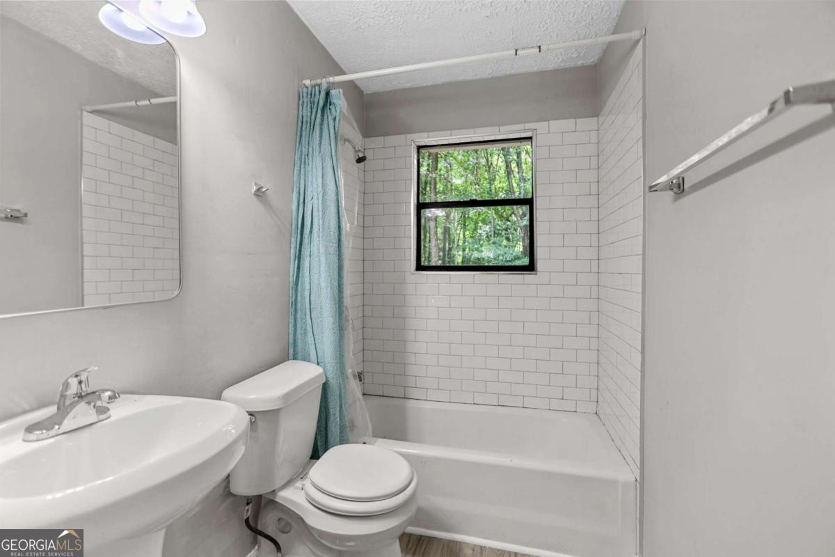 1248 Cannonville Road LaGrange, GA 30240 - Photo 30 of 46 a bathroom with a sink toilet and shower
