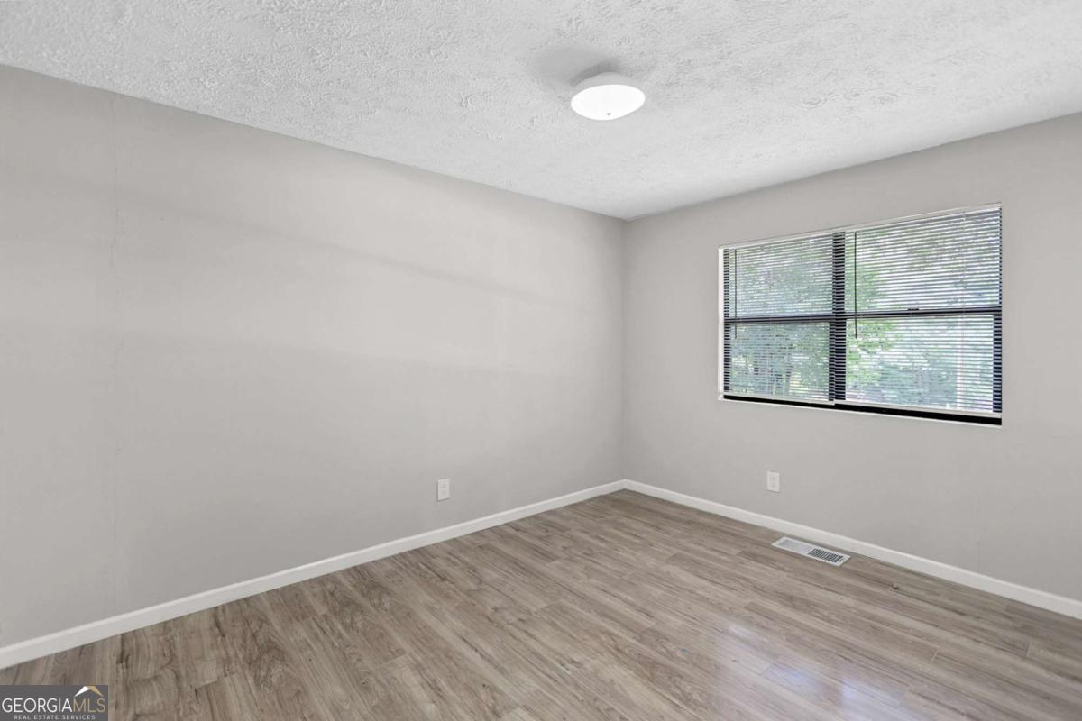 1248 Cannonville Road LaGrange, GA 30240 - Photo 31 of 46 an empty room with wooden floor and windows
