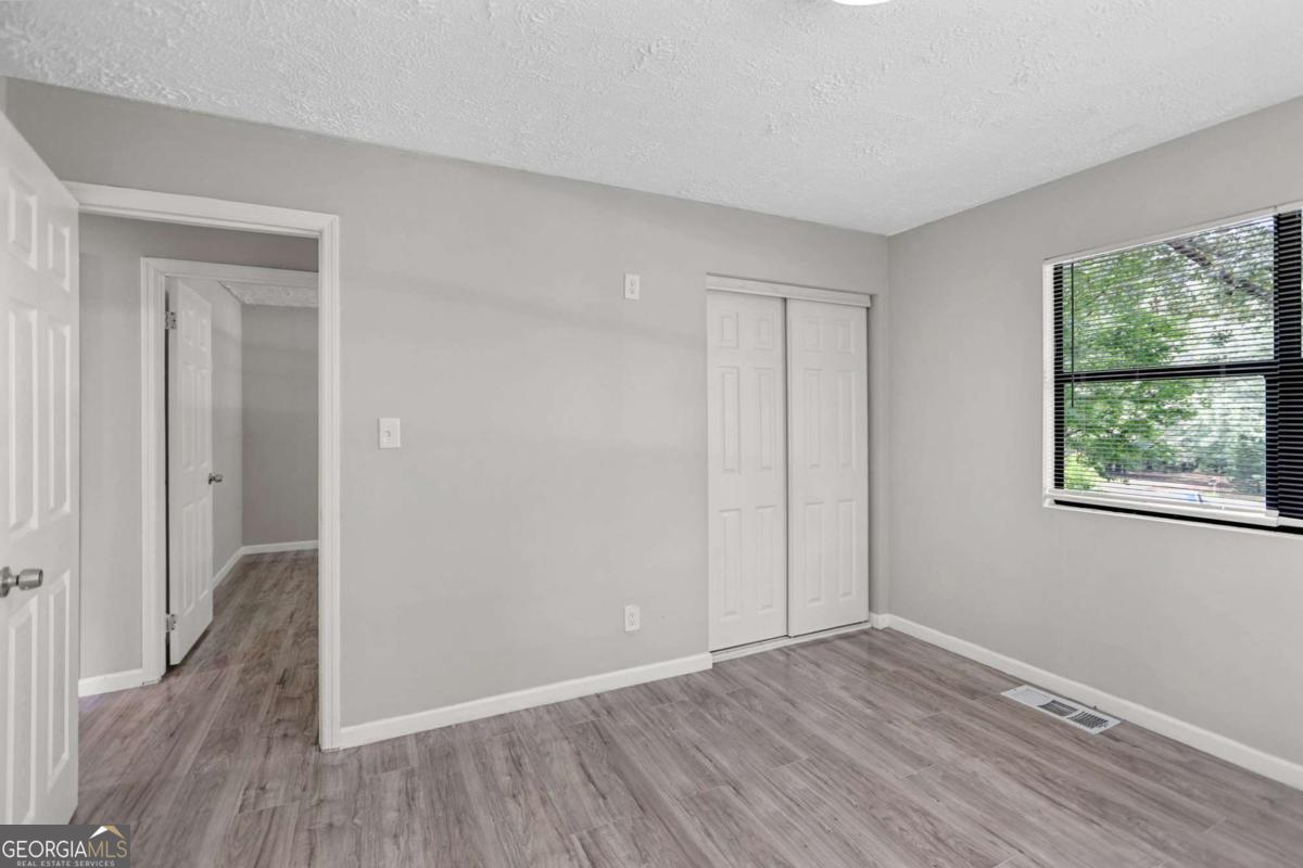 1248 Cannonville Road LaGrange, GA 30240 - Photo 34 of 46 a view of an empty room with wooden floor and a window