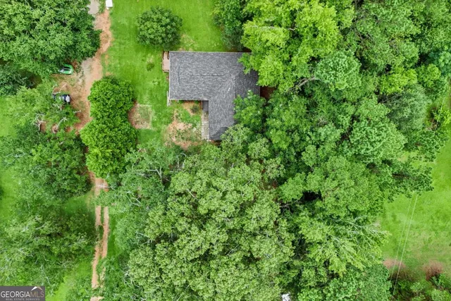 an aerial view of a house with a yard