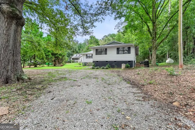 a view of a house with a yard and tree s