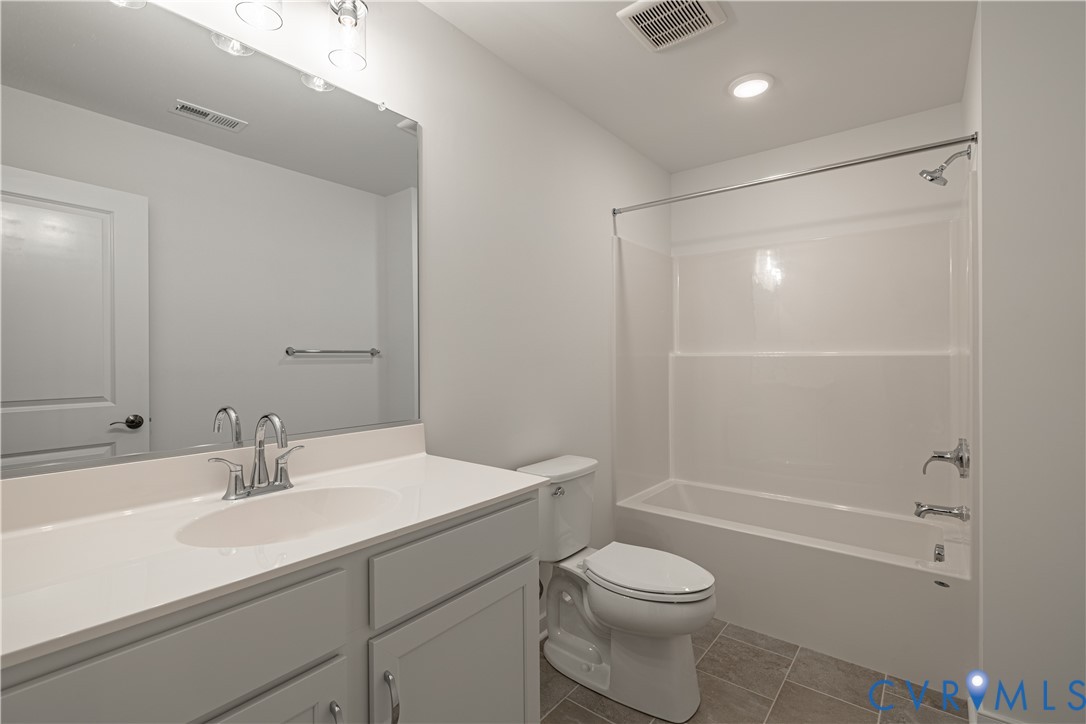 6717 Mayland Ridge Lane Moseley, VA 23120 - Photo 15 of 15 a bathroom with a sink a toilet and shower