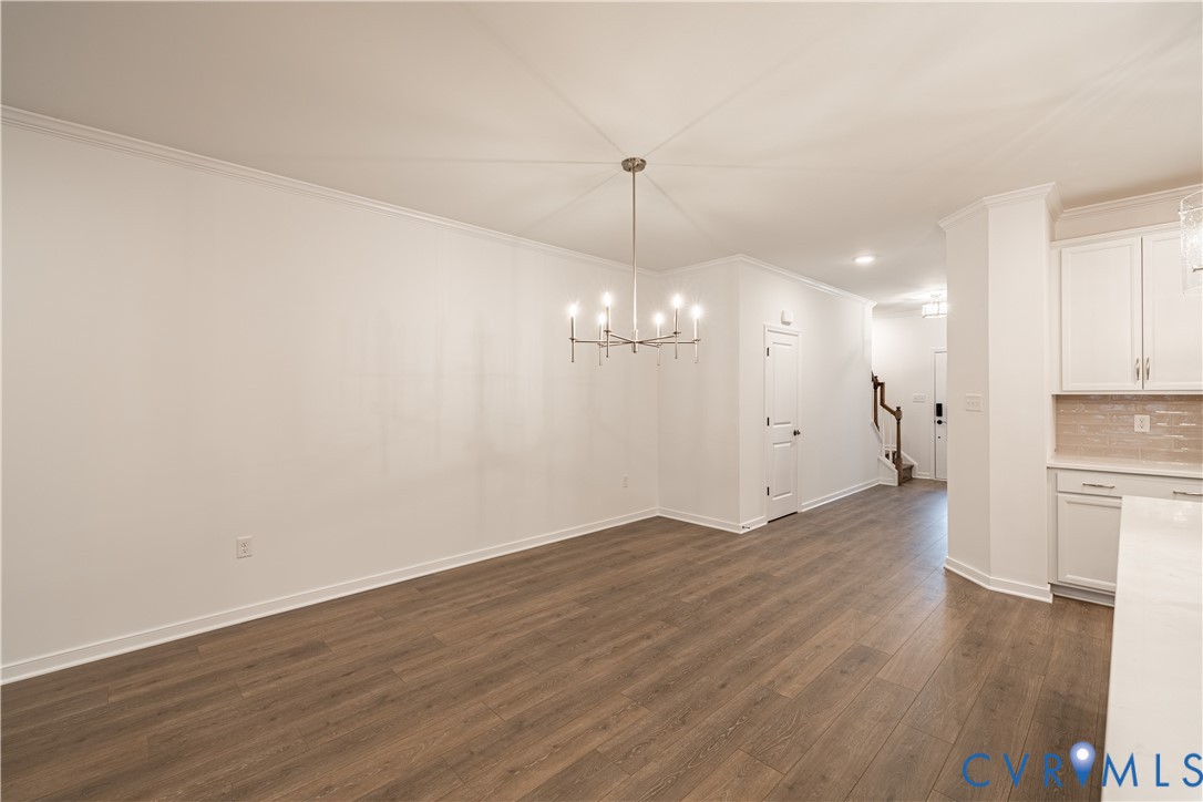 6717 Mayland Ridge Lane Moseley, VA 23120 - Photo 2 of 15 a view of a room with wooden floor and kitchen view