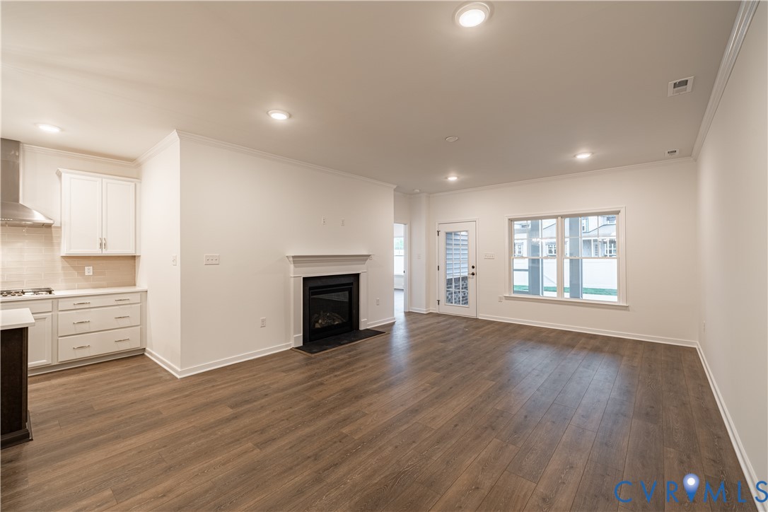 6717 Mayland Ridge Lane Moseley, VA 23120 - Photo 5 of 15 a view of an empty room with window and wooden floor