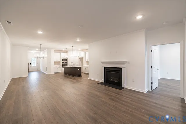 a view of a big room with wooden floor and a fireplace