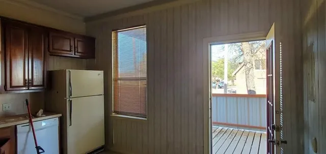 a metallic refrigerator freezer sitting in a kitchen