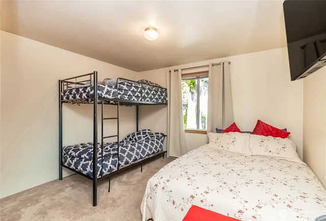 a bedroom with two beds and a window