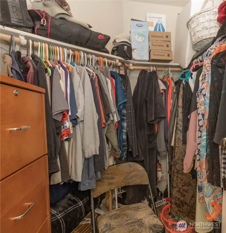 a view of walk in closet with clothes