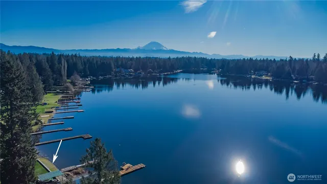 a view of residential house with outdoor space and lake view