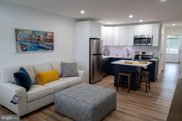 a living room with furniture a refrigerator and a dining table