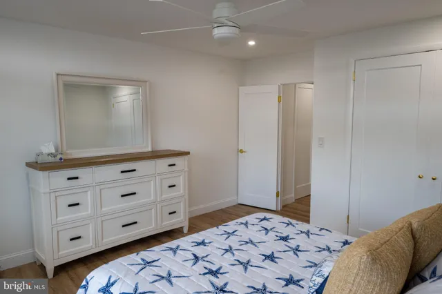 a bedroom with a bed and a dresser in it