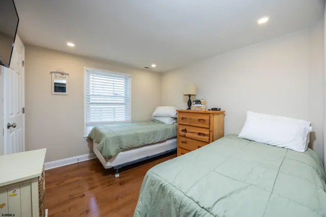 a bedroom with two beds and a desk