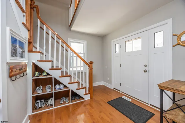 a view of entryway with wooden floor and stairs