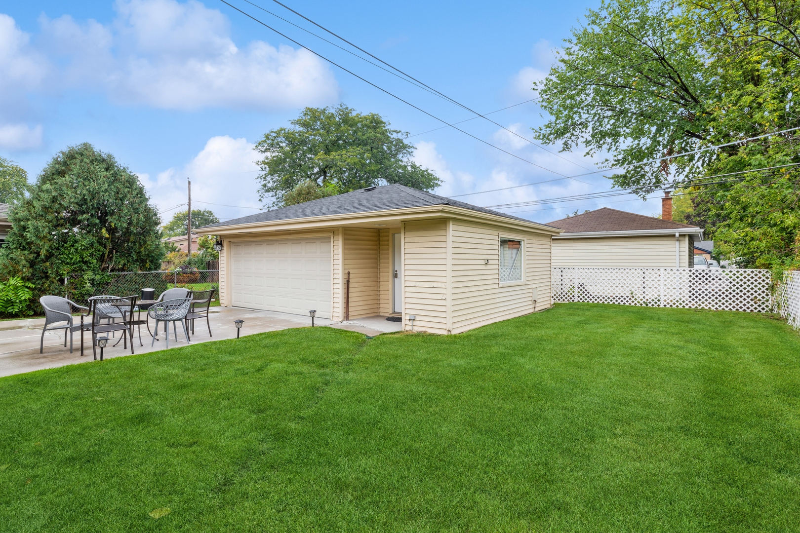 1409 Lahon Street Park Ridge, IL 60068 - Photo 18 of 21 a view of a backyard with table and chairs and a large tree