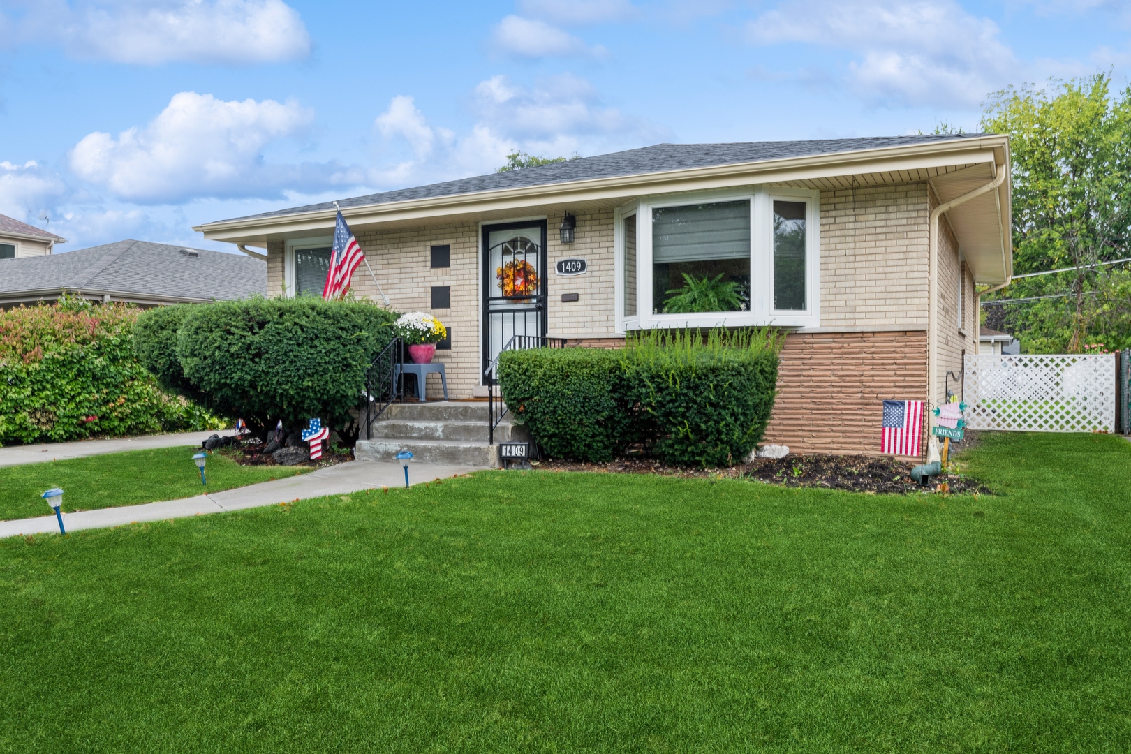 1409 Lahon Street Park Ridge, IL 60068 - Photo 2 of 21 a front view of a house with a yard and garage