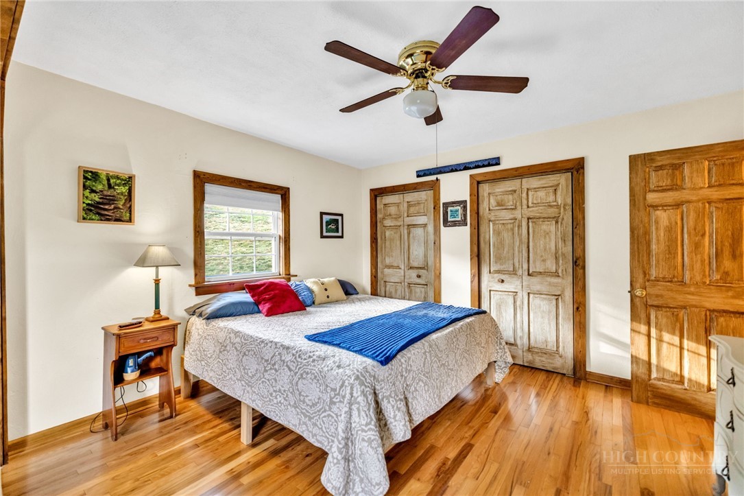 242 Ladd Parson Road Crumpler, NC 28617 - Photo 18 of 36 a bedroom with a bed and a table