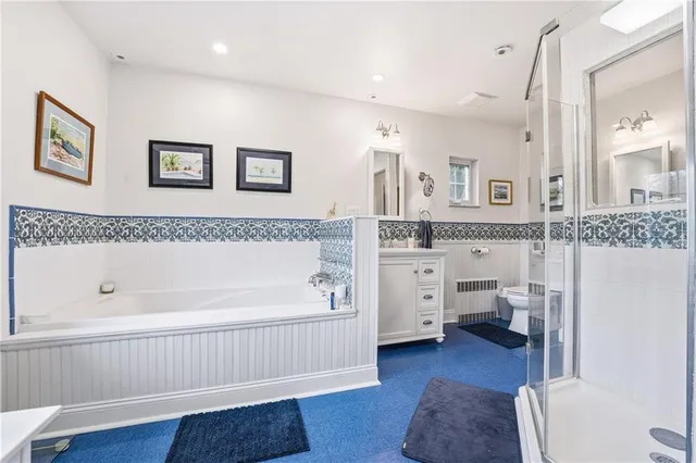 a spacious bathroom with a tub sink and toilet
