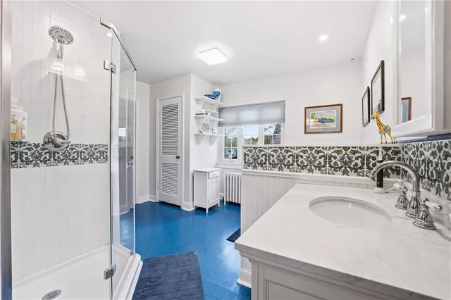 a en suite bathroom with a sink a mirror a vanity and shower