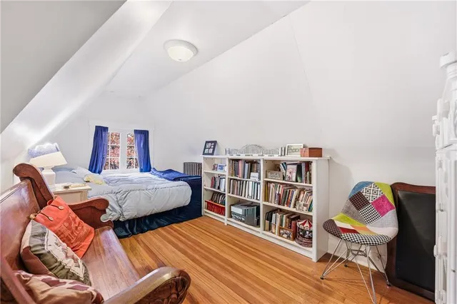 a bedroom with a bed and a book shelf