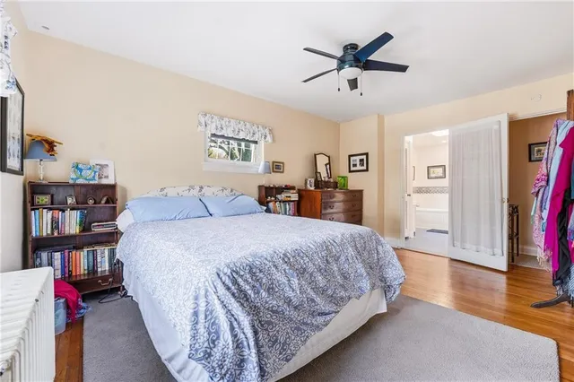 a bedroom with a bed furniture and a book shelf