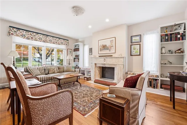 a living room with furniture a rug and a fireplace