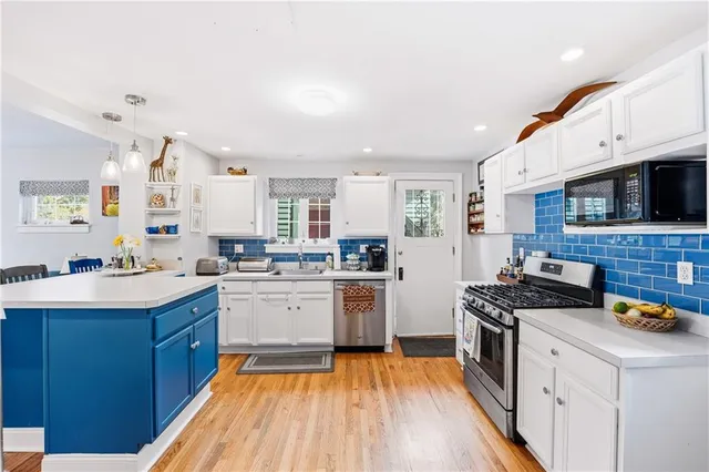a kitchen with a sink stove top oven and cabinets