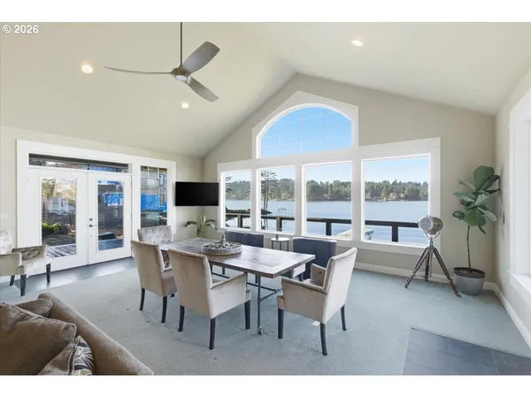 a living room with lots of furniture and view of kitchen
