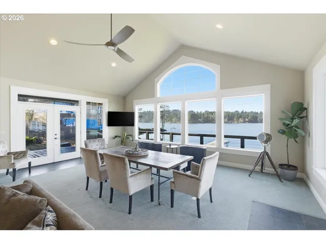 a living room with lots of furniture and view of kitchen