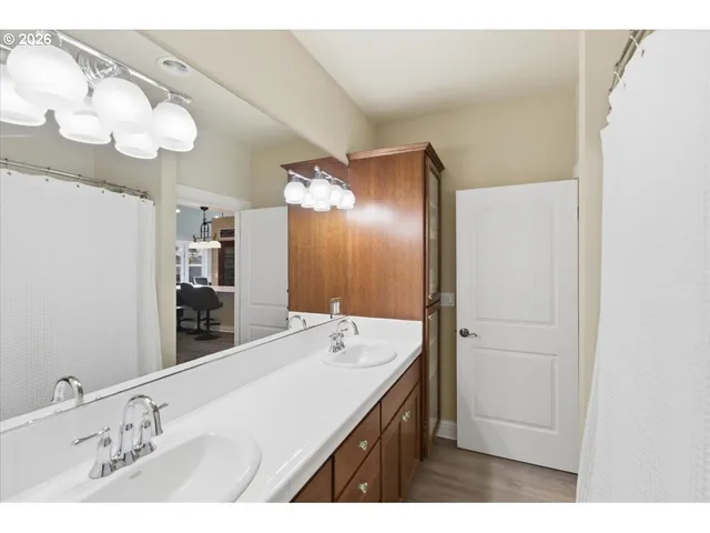 a bedroom with a bed ceiling fan and a window