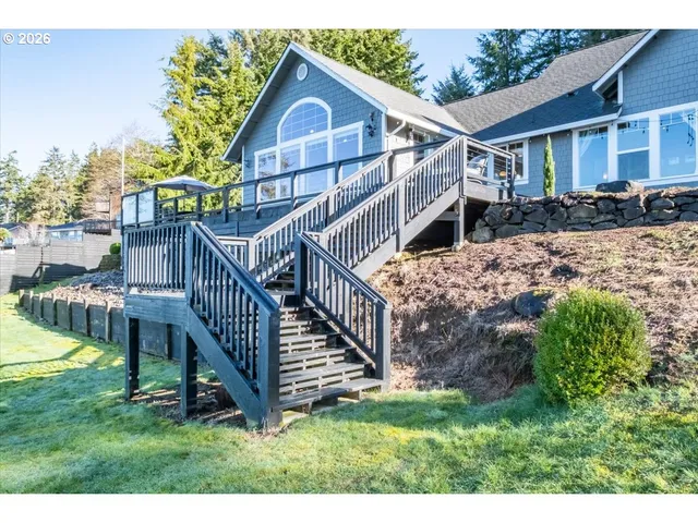 a view of house with a yard and deck