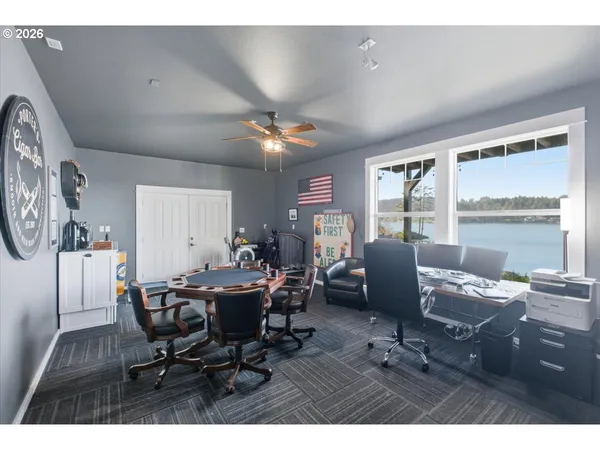 a living room with furniture and a dining table