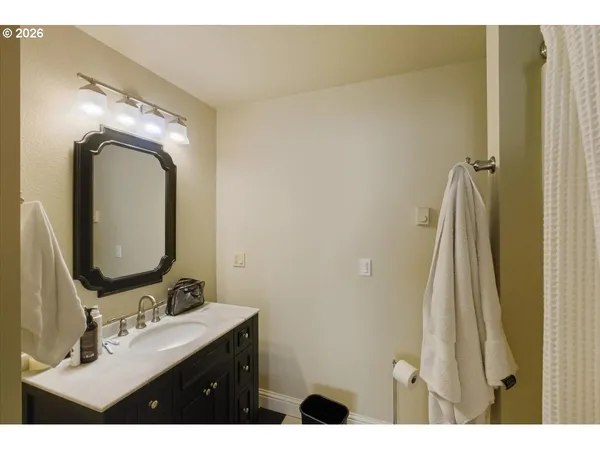 a view of a dry yard with wooden fence
