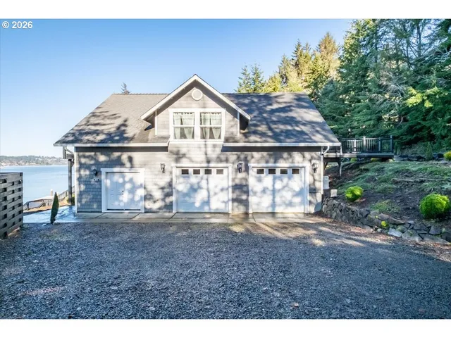a view of a patio with table and chairs potted plants and floor to ceiling window