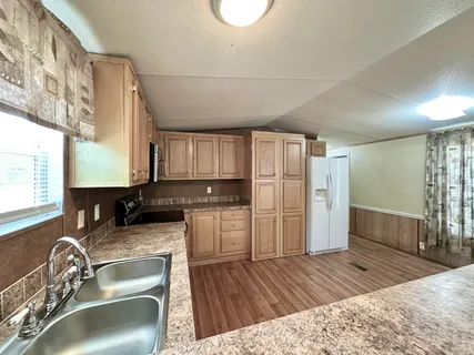 a kitchen with a sink and refrigerator