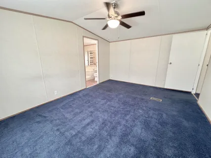 a view of empty room with ceiling fan