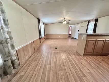 wooden floor in an empty room with a fireplace