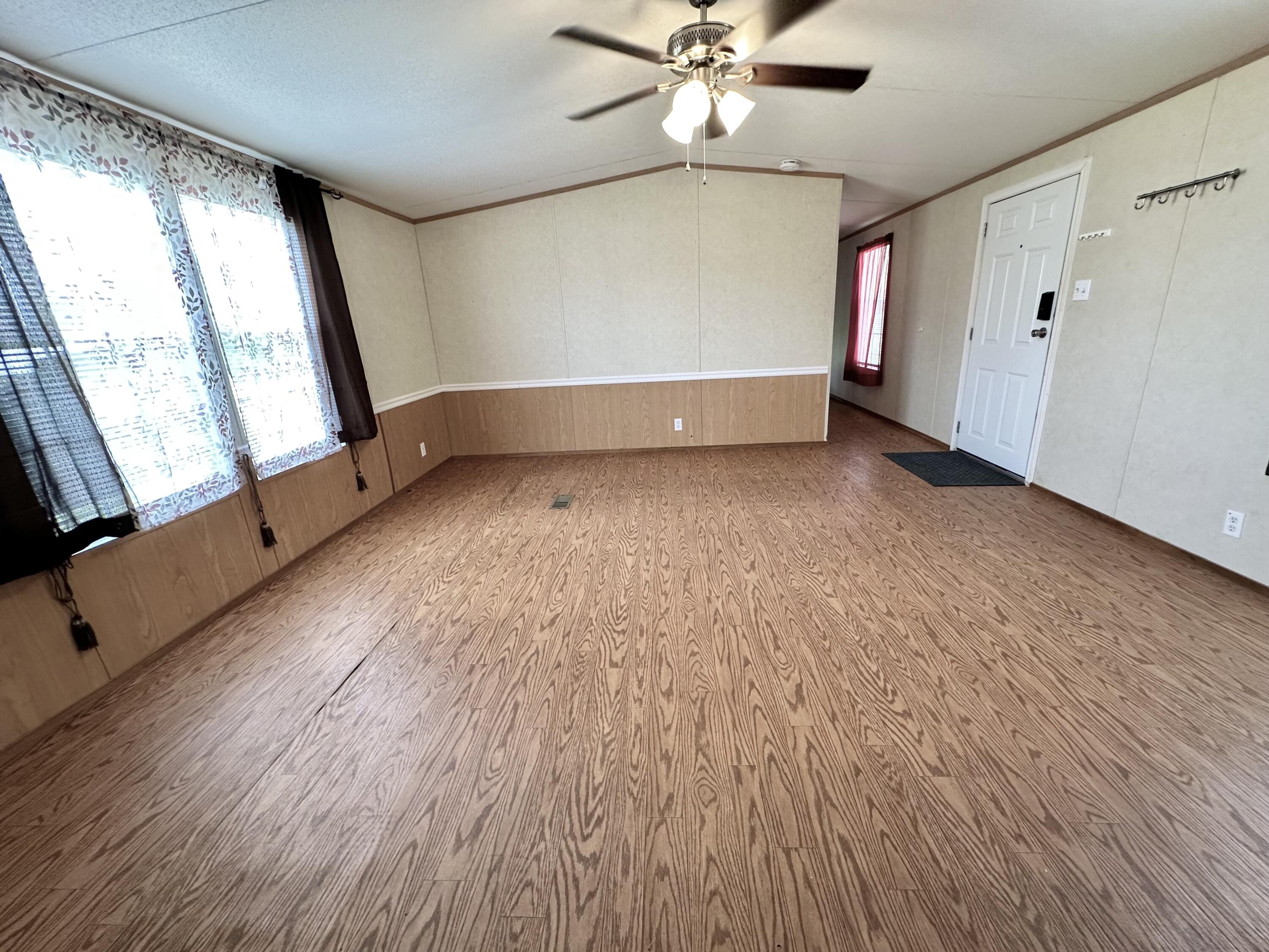 123 Marigold Avenue DeFuniak Springs, FL 32433 - Photo 24 of 45 an empty room with wooden floor fan and windows