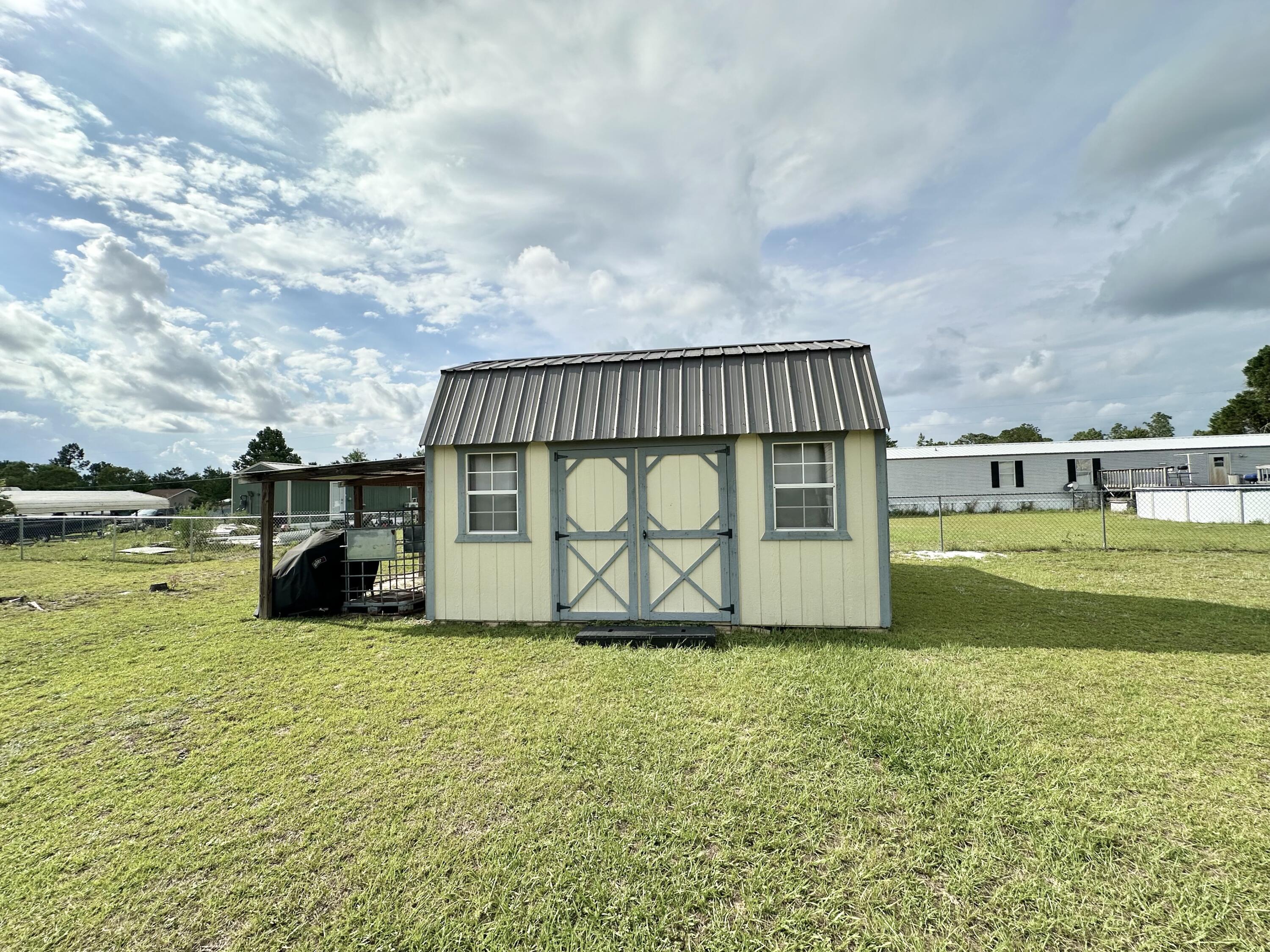 123 Marigold Avenue DeFuniak Springs, FL 32433 - Photo 3 of 45 a view of a garden