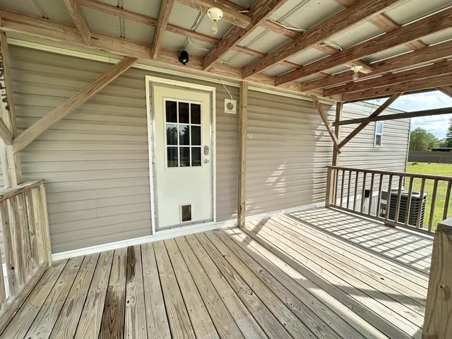 a view of a wooden chairs on a balcony