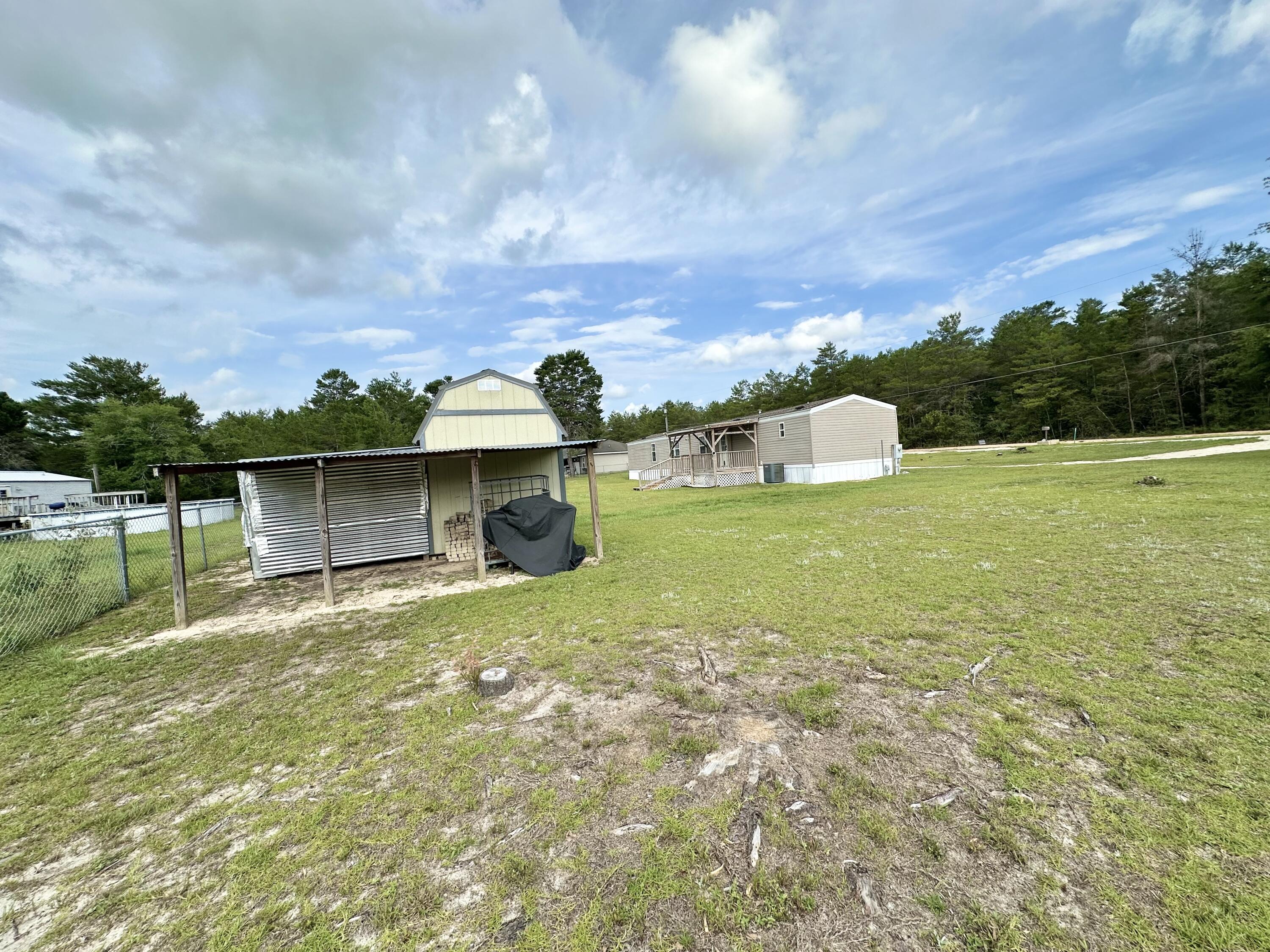 123 Marigold Avenue DeFuniak Springs, FL 32433 - Photo 38 of 45 a view of a house with a yard