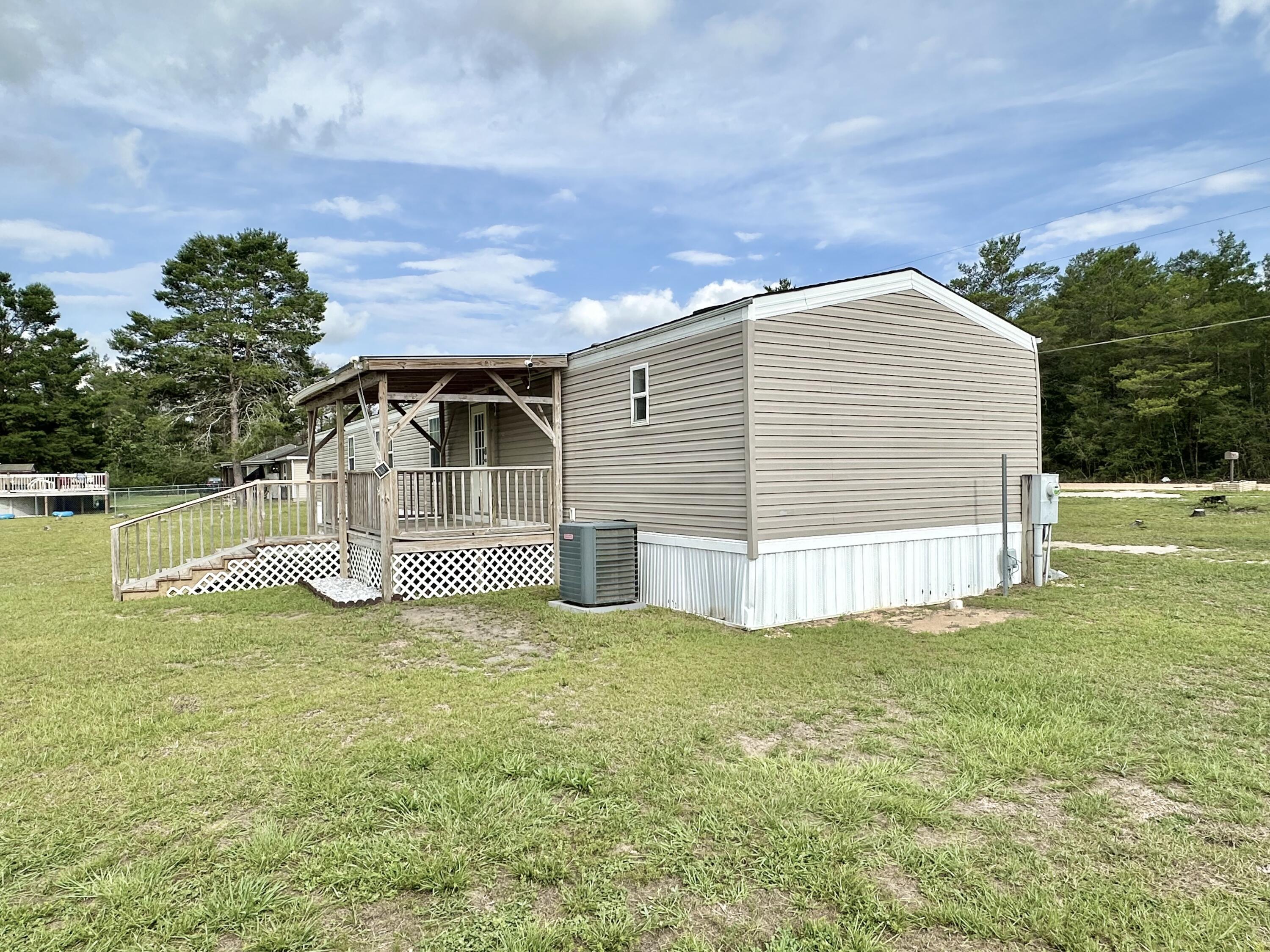 123 Marigold Avenue DeFuniak Springs, FL 32433 - Photo 39 of 45 a view of a house with a yard