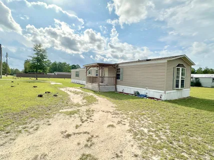 a view of a swimming pool with a yard
